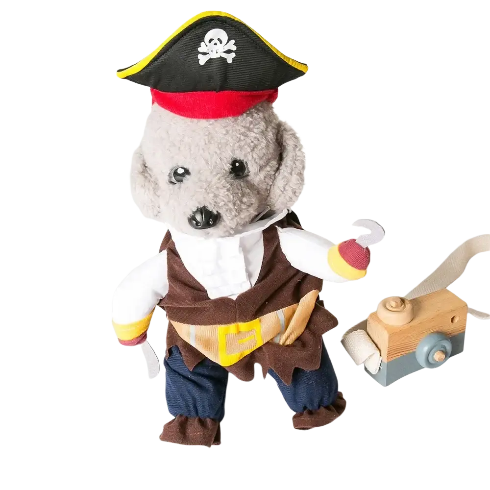 A gray plush dog in a pirate costume with black tricorn hat skull and crossbones holding a wooden toy camera