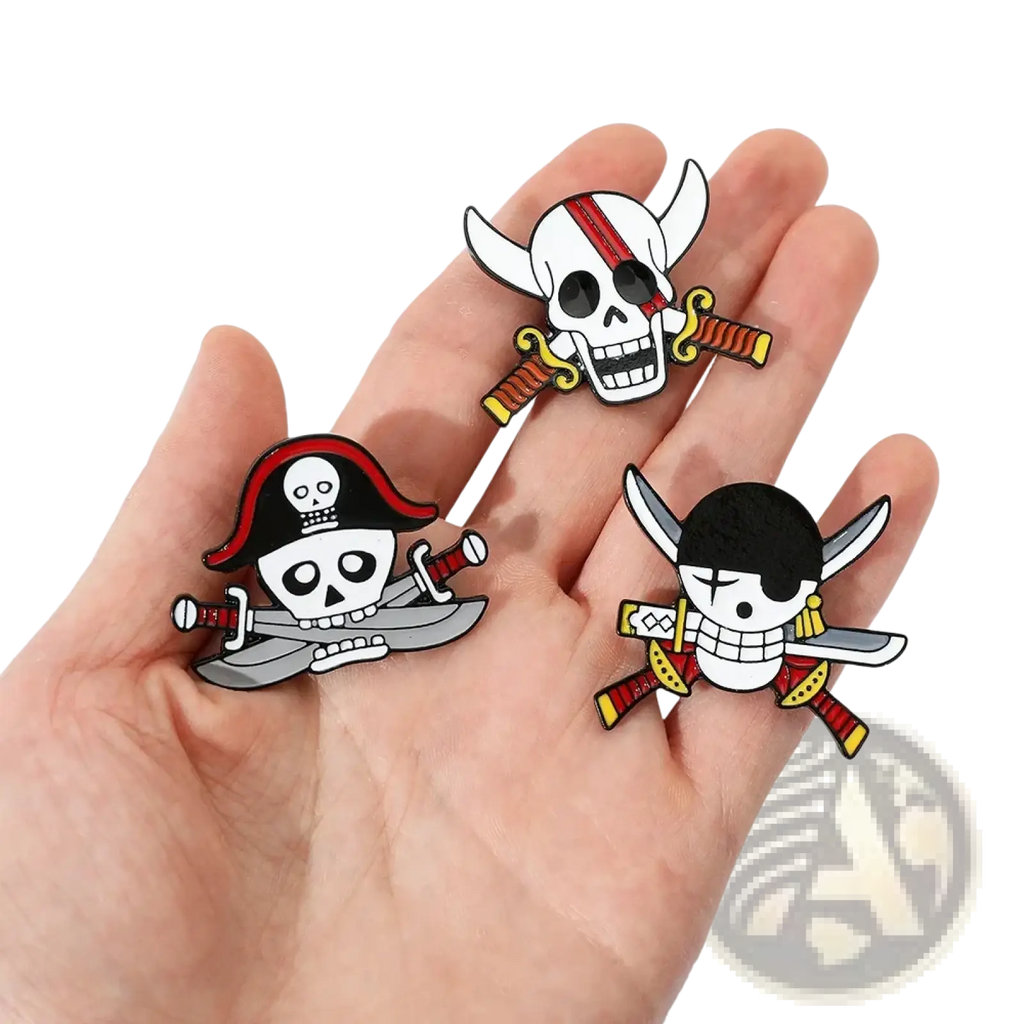 Three enamel pirate-themed pin badges featuring skull and crossbones designs with red white black silver gold and yellow accents