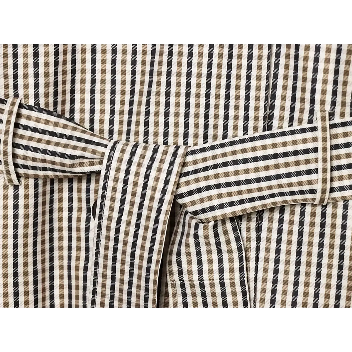 A plaid belted short trench jacket featuring a beige and black striped fabric belt with a subtle checkered pattern