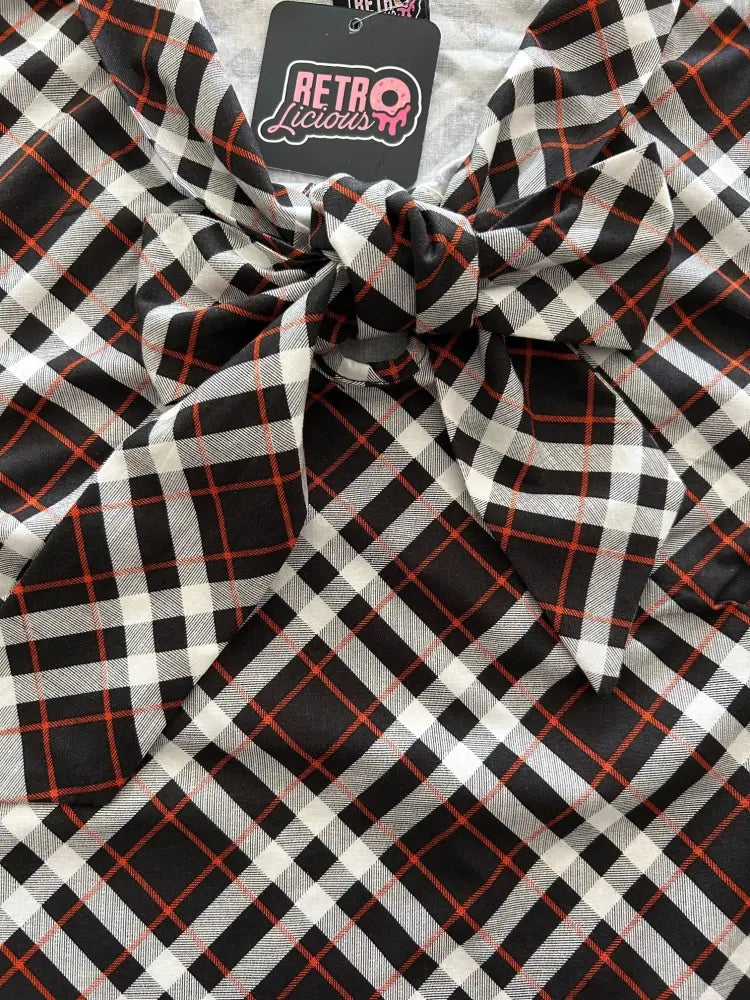 Black white and red plaid sleeveless blouse with oversized bow at neckline suitable for halloween wear