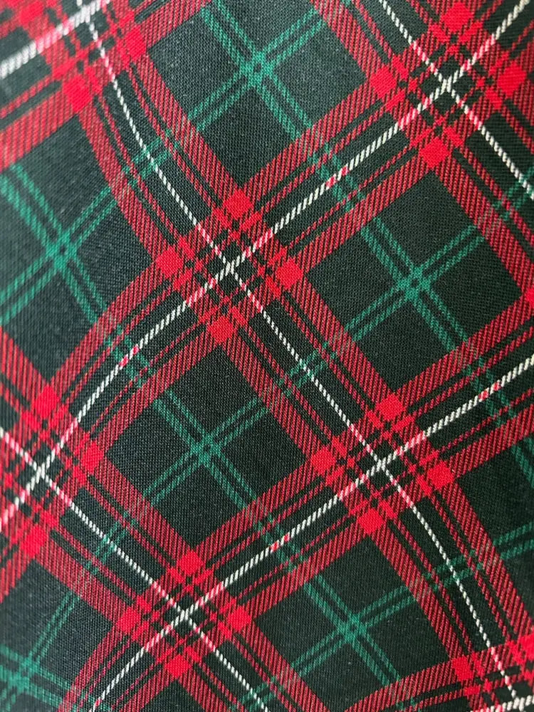 Greta plaid v neck cotton a line dress with pockets featuring red green and black plaid fabric with white stitching details