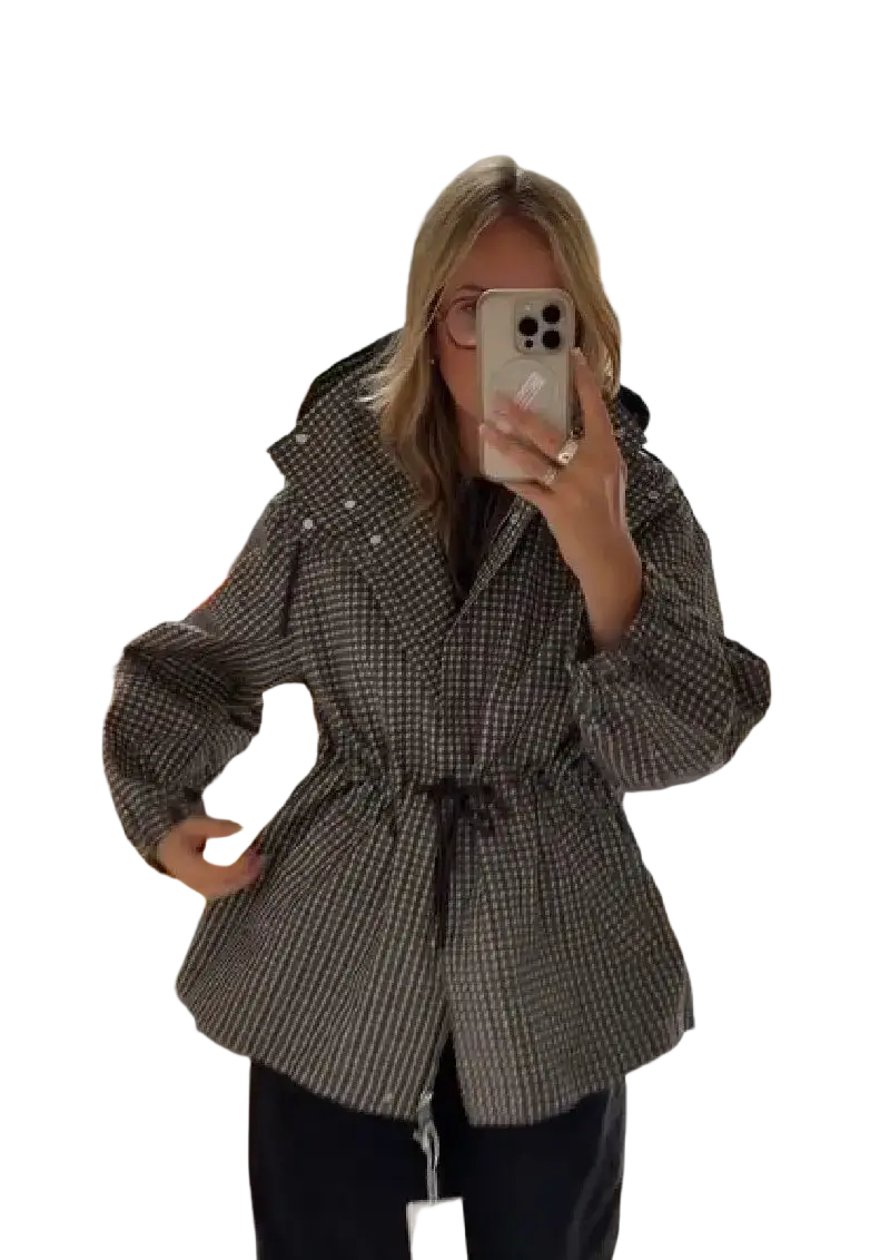 A stylish plaid hooded trench jacket for women in muted grey and black herringbone with a cinched waist belt