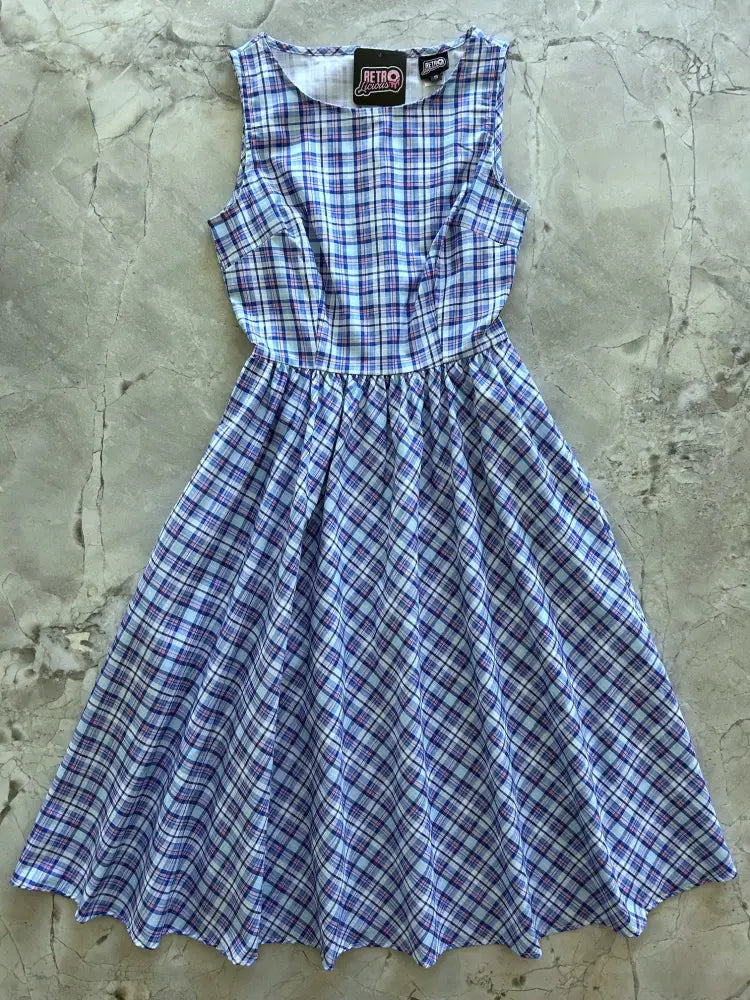 A sleeveless blue and cream plaid 1950s cotton midi swing dress with a fitted bodice and flared skirt