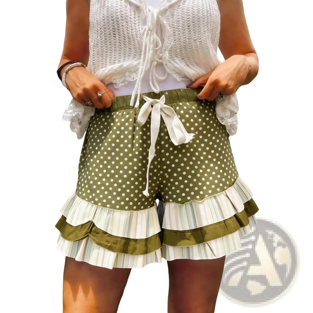 Olive green shorts with white polka dots feature layered striped ruffles and a matching drawstring waist in plaid patchwork style