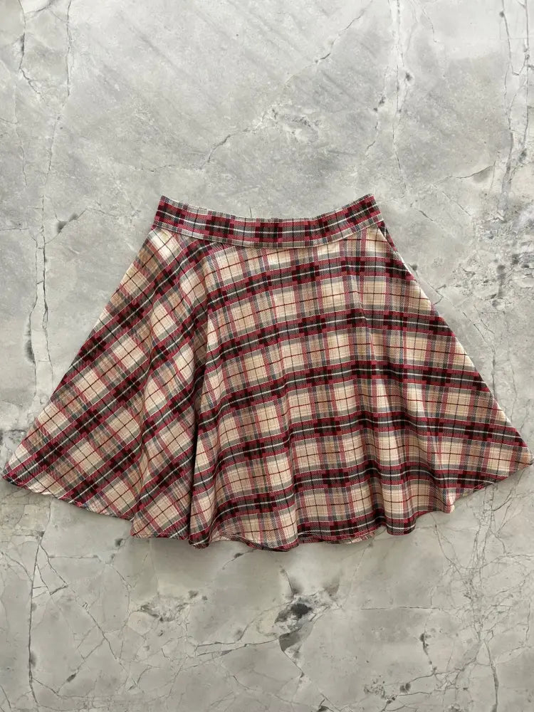 A flared red navy plaid cotton skater skirt with elastic waist featuring red beige and black pattern