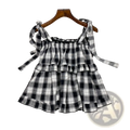 Black and white plaid tiered mini dress with adjustable bow shoulder straps in lightweight fabric for casual wear