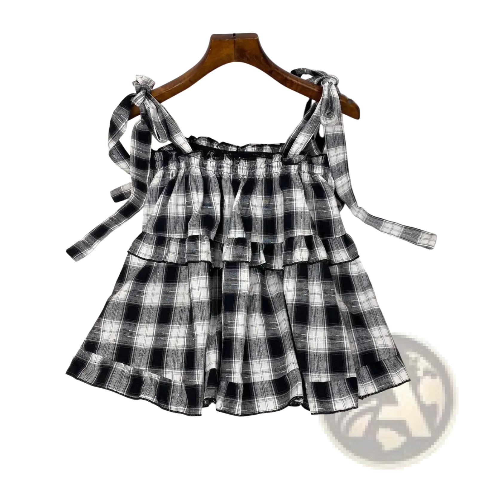 Black and white plaid tiered mini dress with adjustable bow shoulder straps in lightweight fabric for casual wear