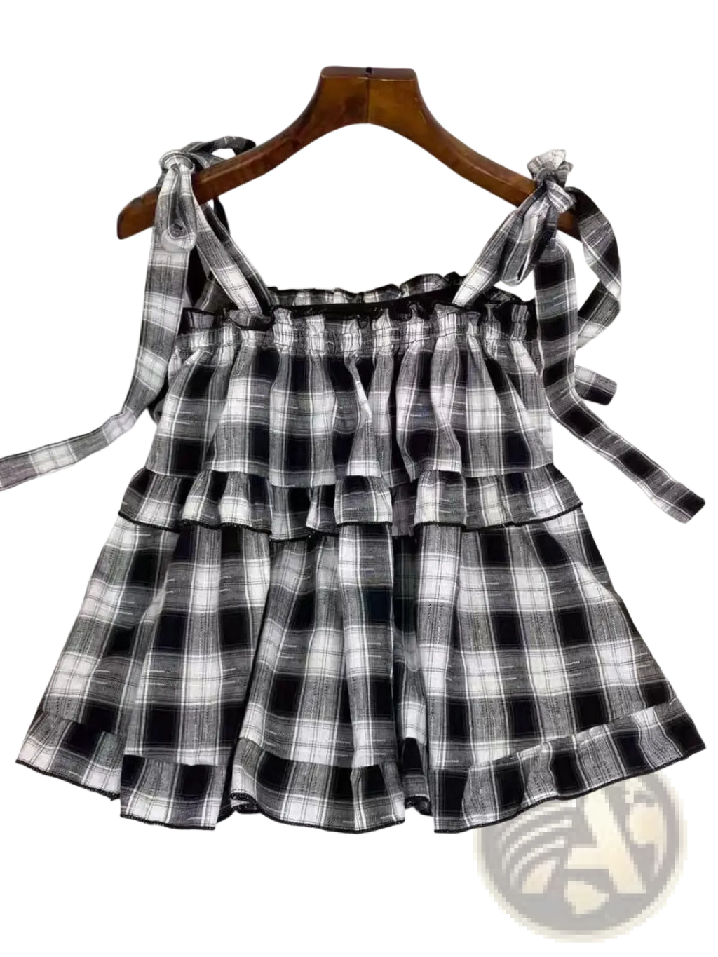 Black and white plaid tiered mini skirt with tied shoulder straps in lightweight fabric for casual wear