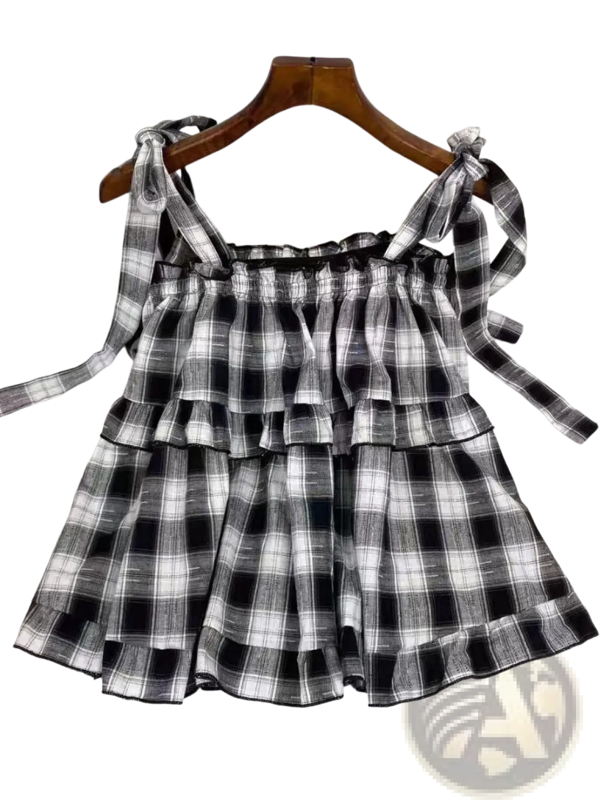 Black and white plaid tiered mini skirt with tied shoulder straps in lightweight fabric for casual wear