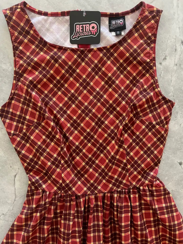A sleeveless cranberry plaid cotton vintage 1950s a-line dress with gathered waist and ruffled hem from Retrolicious