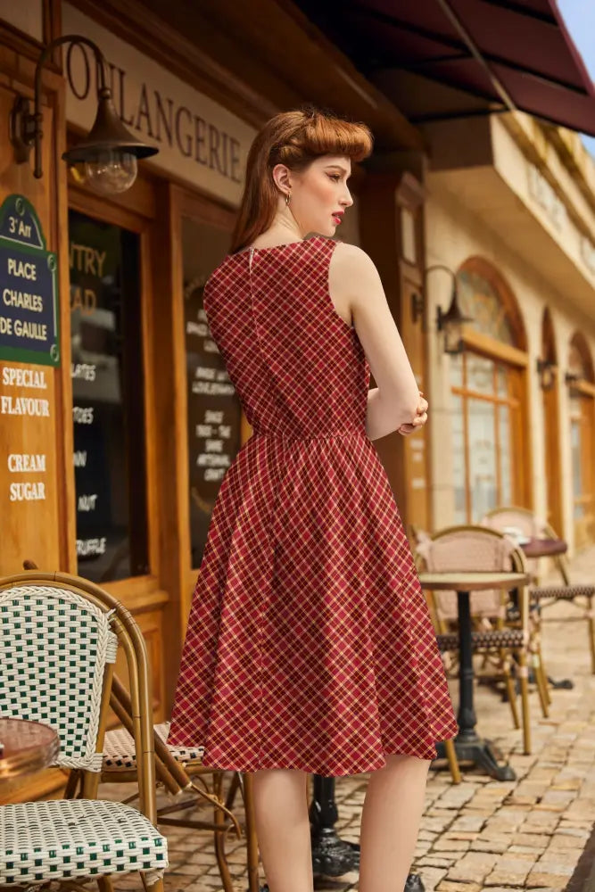 A red and white checkered sleeveless cranberry plaid vintage 1950s cotton a-line dress with fitted waist and pockets