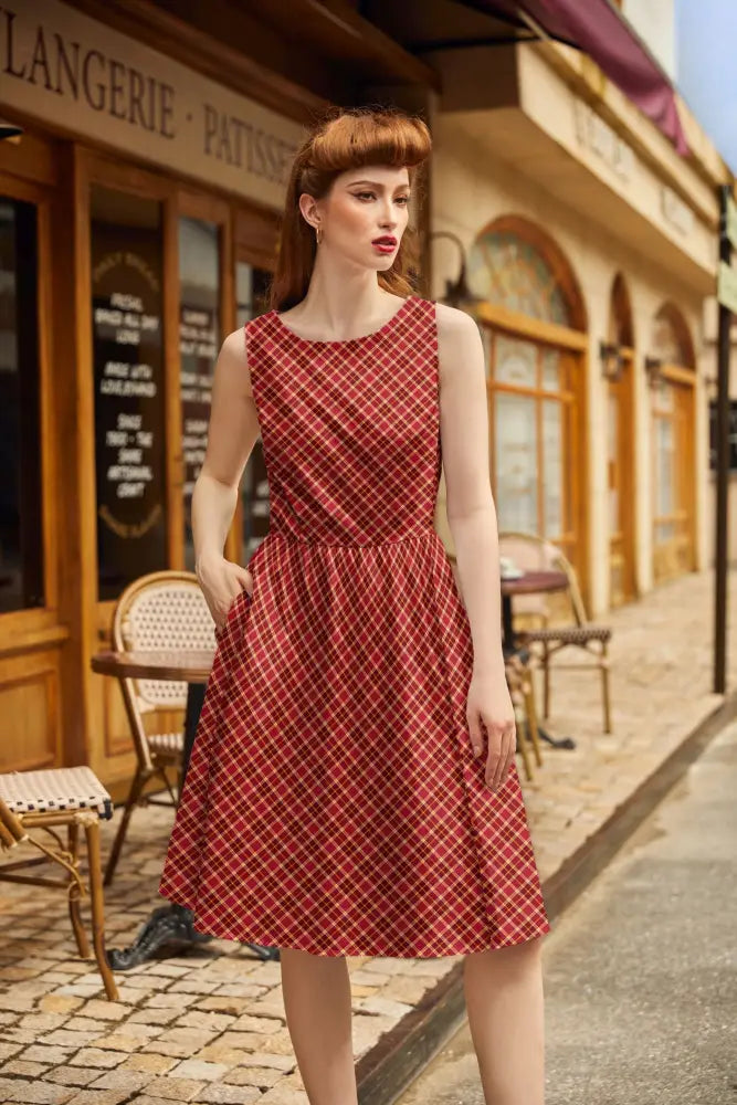 A red and white checkered sleeveless cotton a-line dress with a fitted bodice and pockets vintage 1950s style