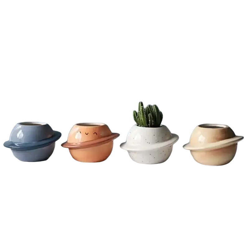 Four ceramic planet-shaped succulent pots with rings in blue orange white and beige for desktop decor