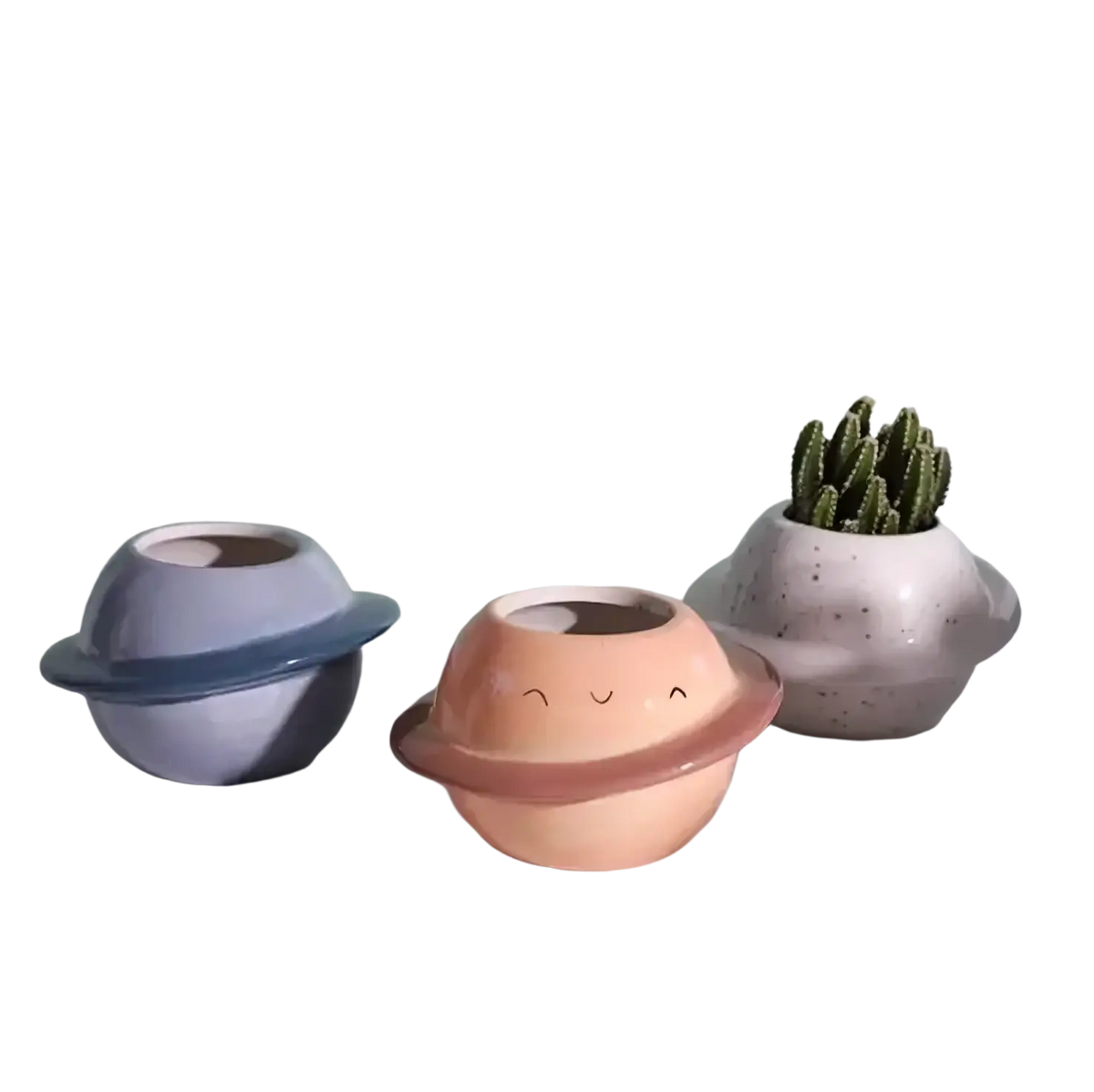 Pastel-colored ceramic planet-shaped succulent pots with smiling faces and ring details for desktop use