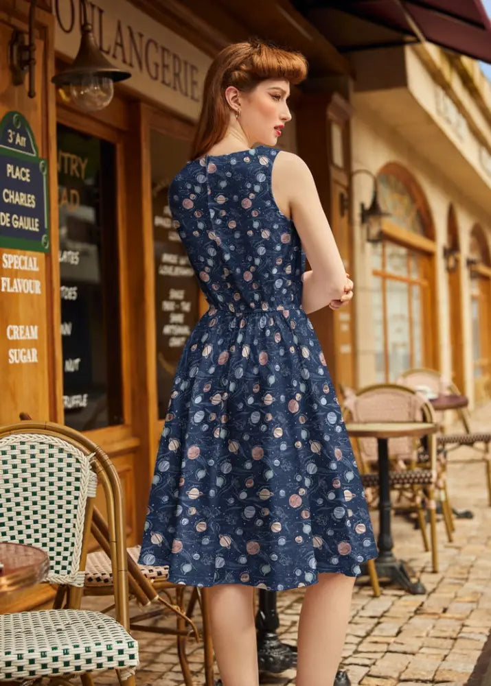 Vintage 1950s navy cotton a-line dress with fitted waistband and soft pink and white floral pattern with pockets