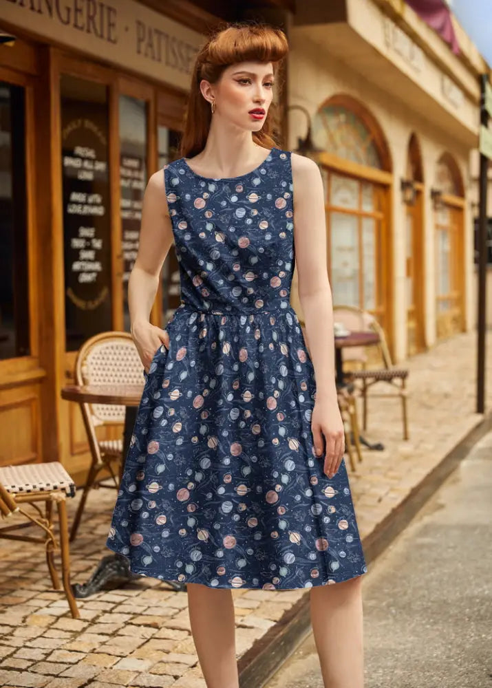 Navy celestial cotton sleeveless a-line dress with pockets featuring planets and stars in soft pinks blues and whites