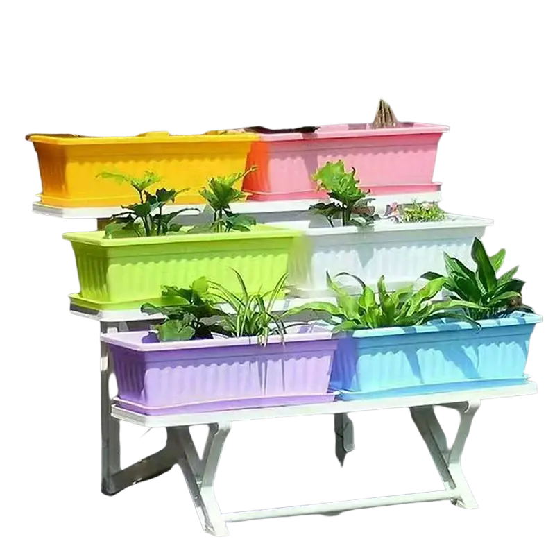 Colorful rectangular plastic planting pots in yellow pink green white purple and blue arranged on a tiered stand