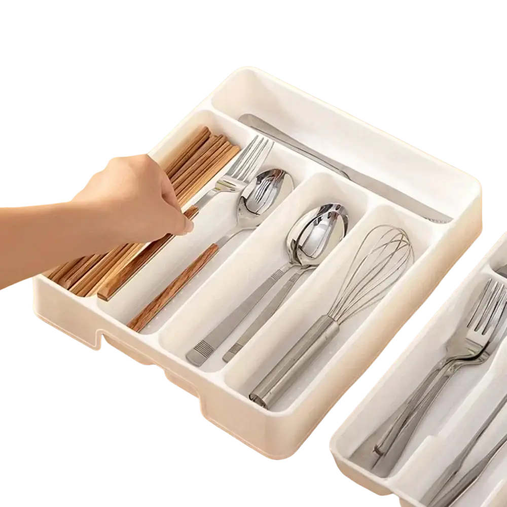 White plastic cutlery drawer organizer with segmented compartments holding forks spoons chopsticks and a whisk