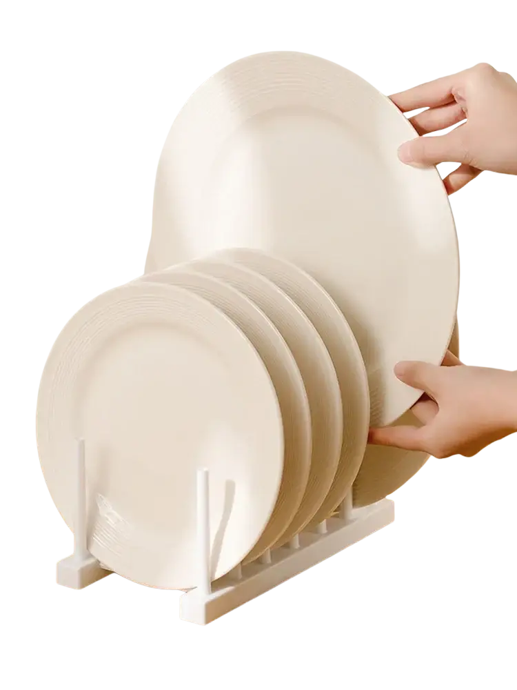 White ceramic plates with subtle ridges stacked on a minimalist white plastic dish drain rack and kitchen organizer