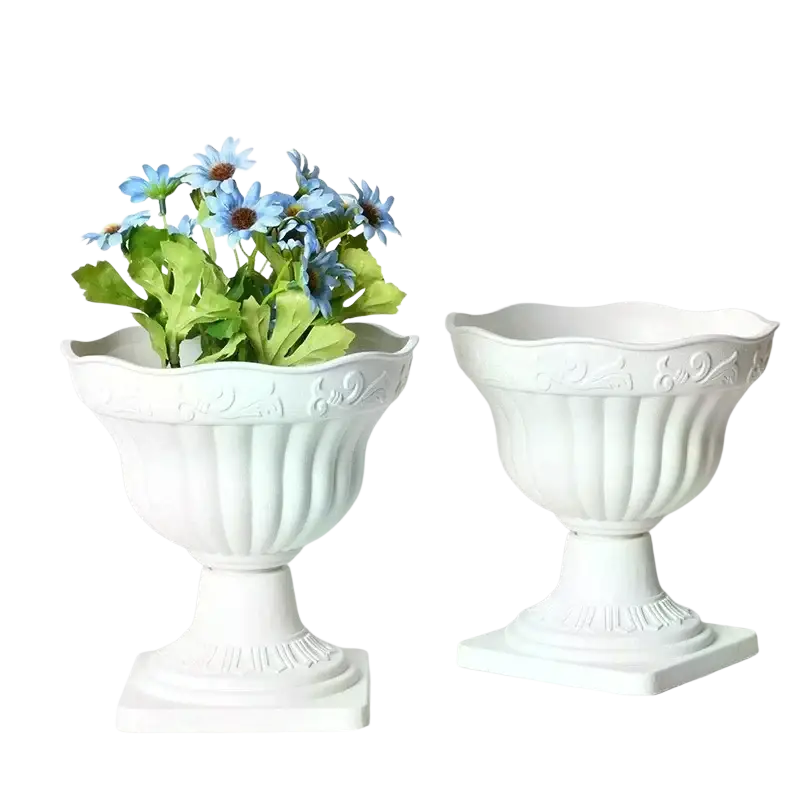 White plastic roman column urn planter with fluted sides and ornate embossed detailing for flowers