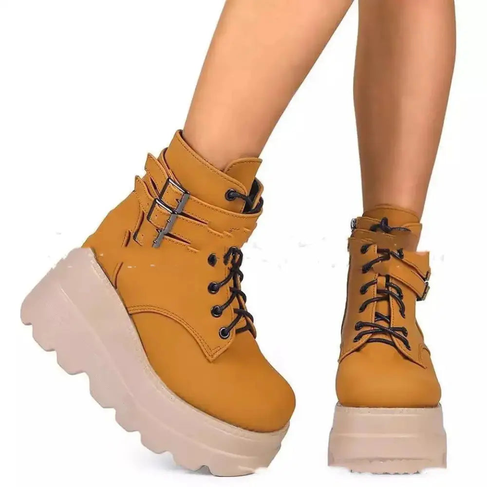 Women’s lace up leather thigh high platform boots in tan with black laces and silver buckle accents