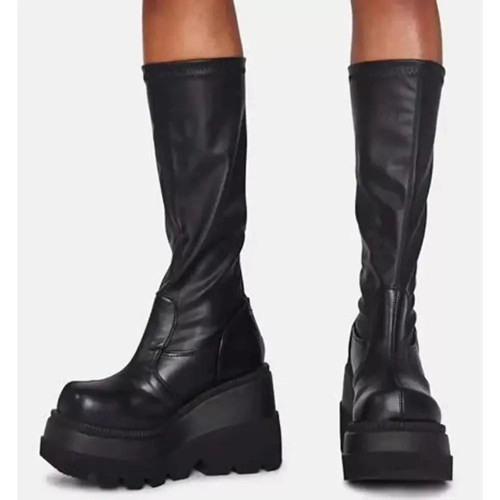 Women’s lace up leather thigh high platform boots in black with sleek glossy finish and thick soles