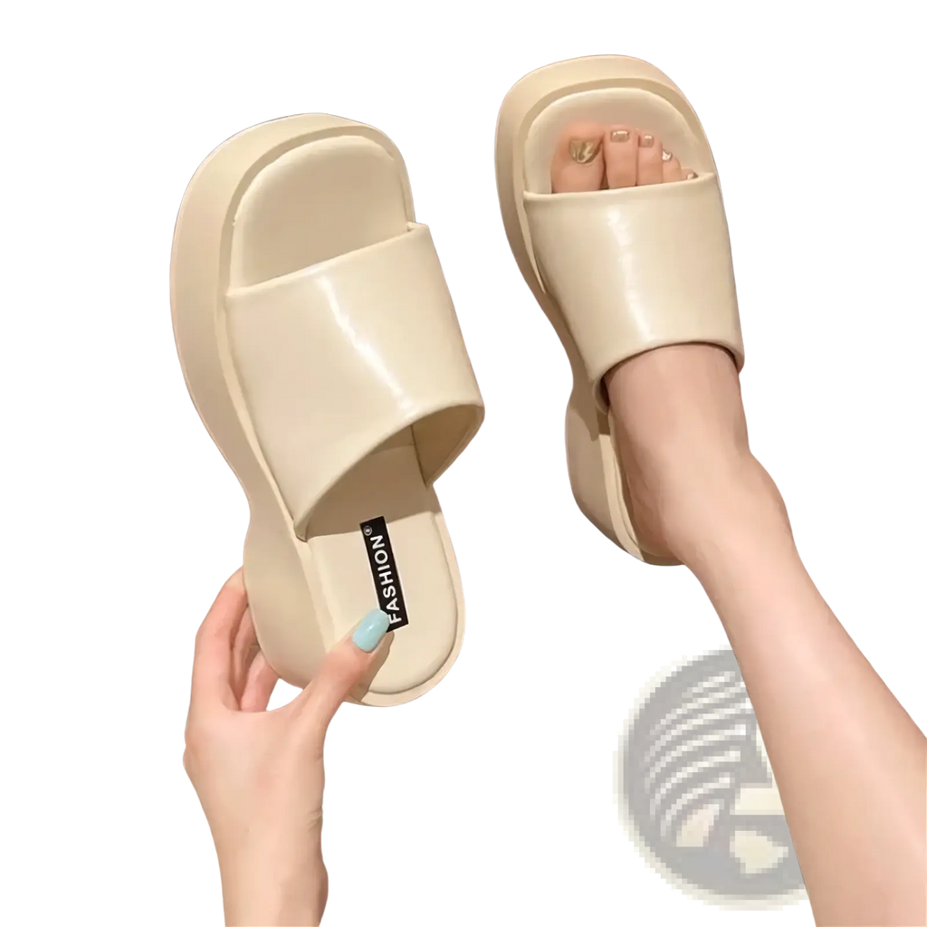 Cream-colored platform slide sandals with glossy finish and thick cushioned soles for summer wear