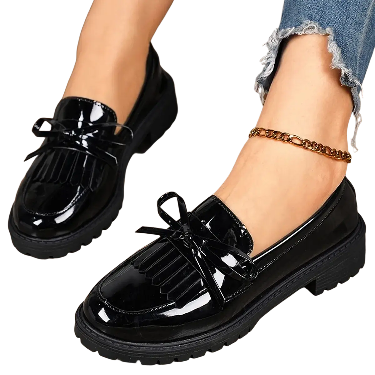 Black patent leather platform tassel loafers for women with glossy finish, decorative fringed bows, and chunky soles