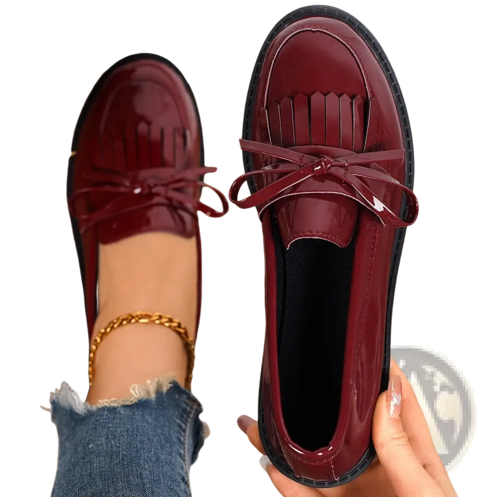 Burgundy patent leather platform tassel loafers for women with fringed front and bow tie detail for casual wear