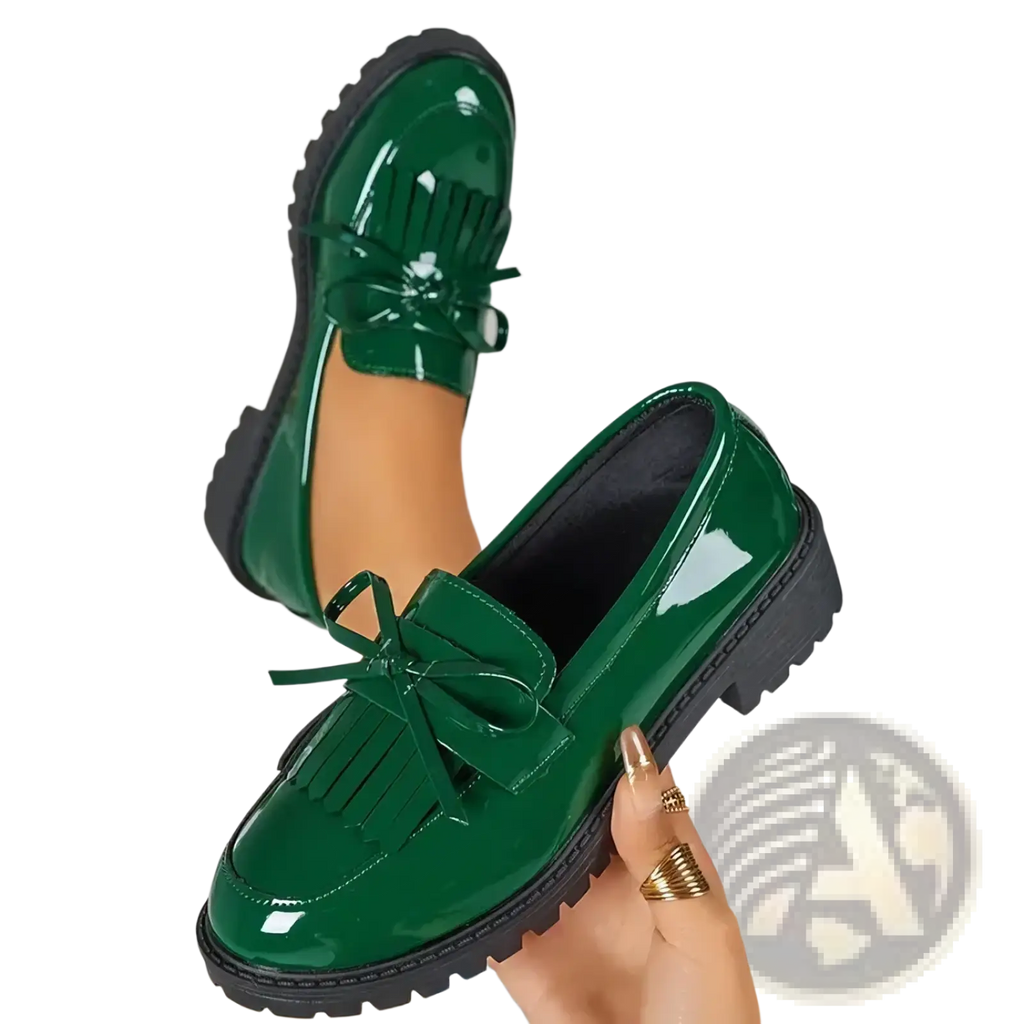 Platform tassel loafers in shiny emerald green patent leather with black rubber soles and decorative bows for casual wear