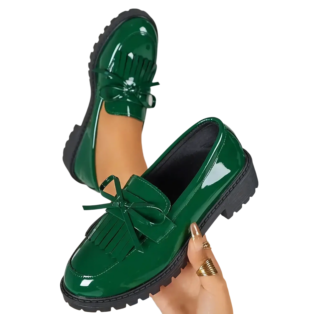 Platform tassel loafers in shiny emerald green patent leather with black rubber soles and decorative bows for casual wear