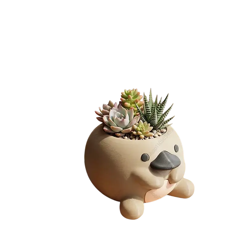 Cute beige ceramic platypus-shaped succulent planter with black beak and pink cheeks for desk decoration