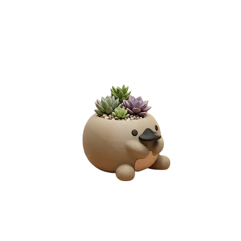 Cute beige ceramic platypus succulent planter with black beak and eyes holding small green and purple succulents