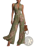 Back view of a flowing green and beige floral print pleated chiffon wide leg jumpsuit with deep v-back zipper detail