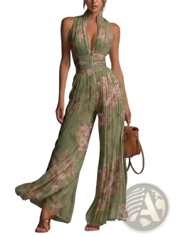 Back view of a flowing green and beige floral print pleated chiffon wide leg jumpsuit with deep v-back zipper detail