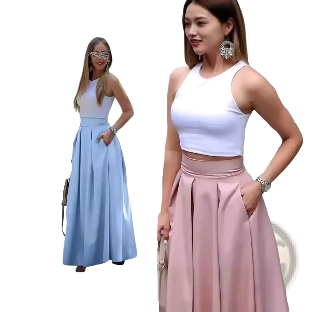 A woman wearing a soft pink pleated high waist maxi skirt with a white crop top in a flowing midi style