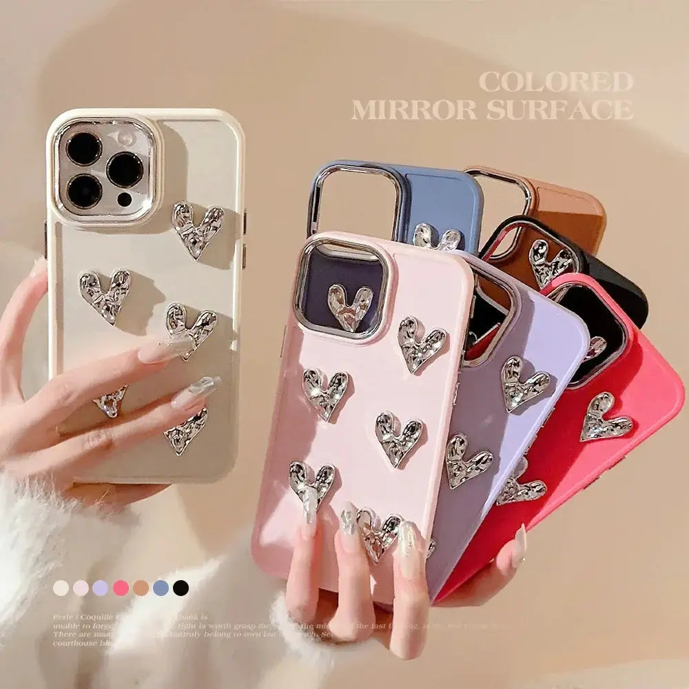 A collection of pleated metallic heart charm phone cases in pastel colors with mirrored finish and silver heart embellishments