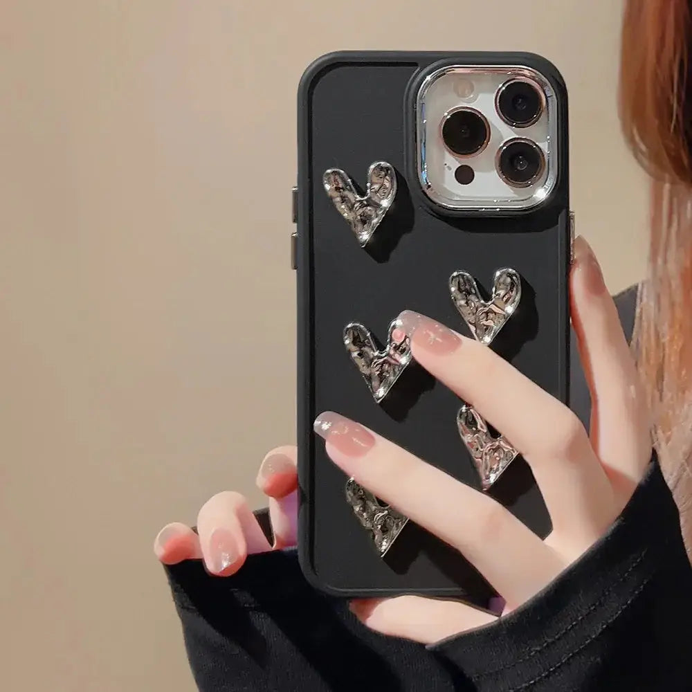 Black pleated metallic heart charm phone case back side with five silver textured heart-shaped embellishments
