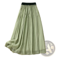 A flowing sage green linen midi pleated skirt with a black elastic waistband in viscose a-line design