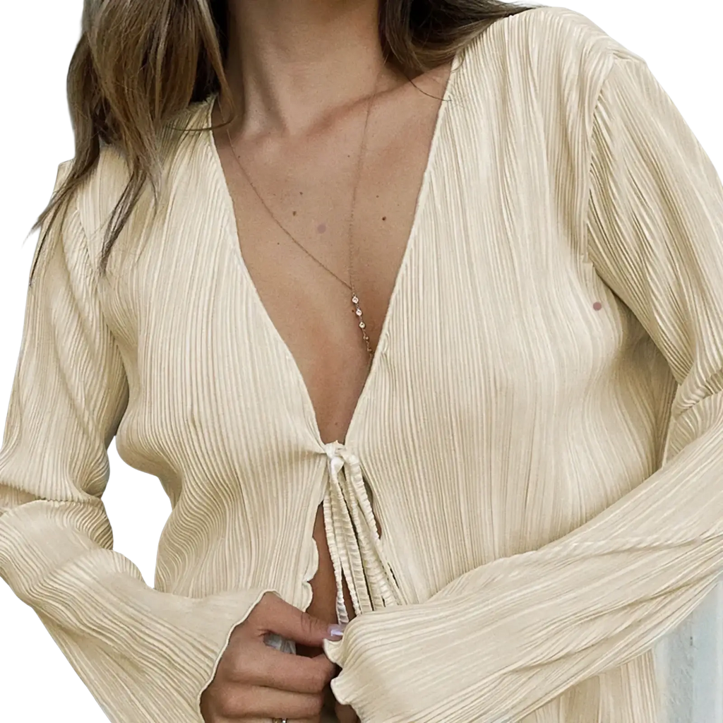 A soft cream-colored pleated v neck tie cardigan blouse with long sleeves and textured fabric for elegant wear