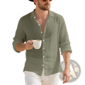 A man wearing a plus size mens sage green linen Hawaiian long sleeve shirt with rolled-up sleeves
