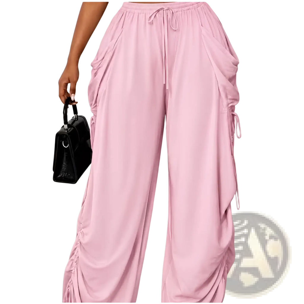 Soft pink plus size ruched athletic pants with flowing fabric side panels and adjustable drawstring waist