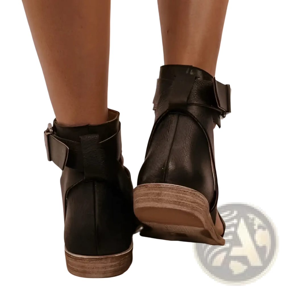 Black leather ankle boots with buckle strap and wooden soles styled as plus size women’s flat roman strappy sandals