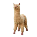 A plush alpaca stuffed animal toy modname=ckeditor with light brown soft curly fur and pink feet on green artificial grass