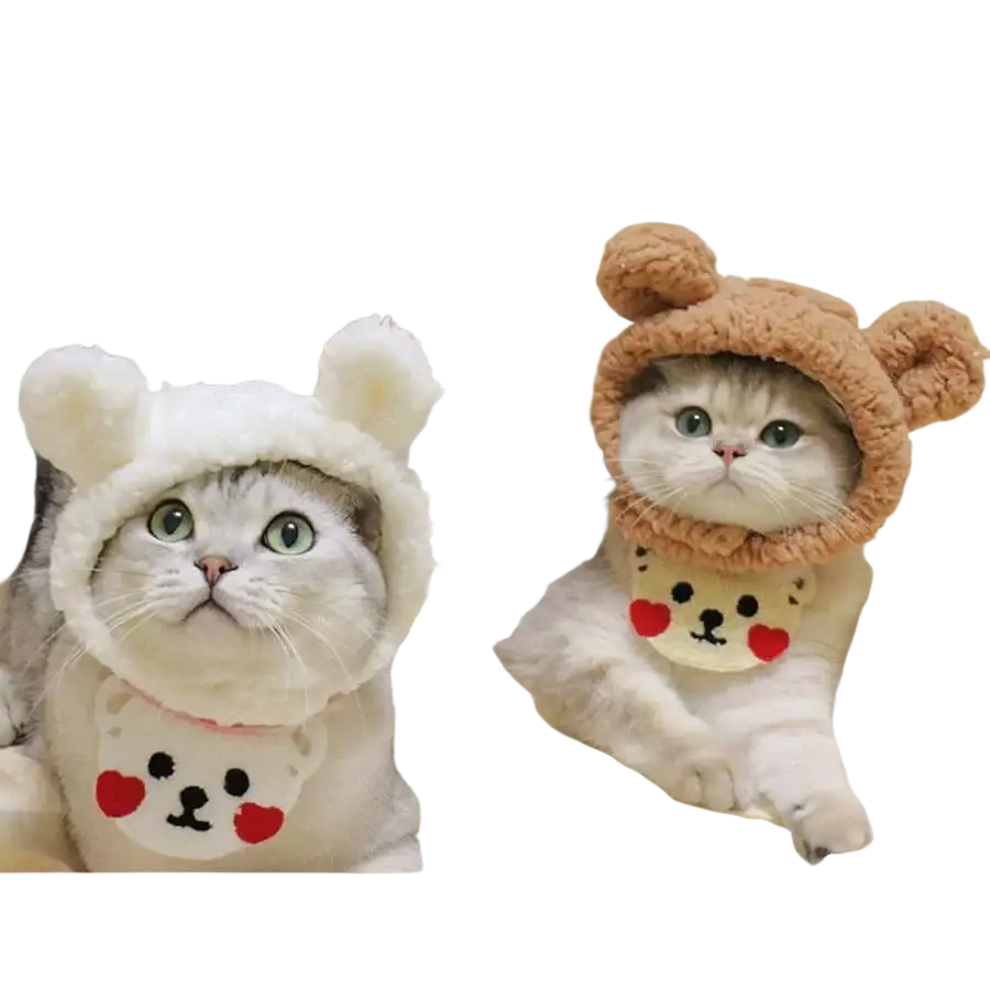 Two fluffy white and gray cats wearing adjustable plush animal pet hats and matching bibs with cute cartoon faces