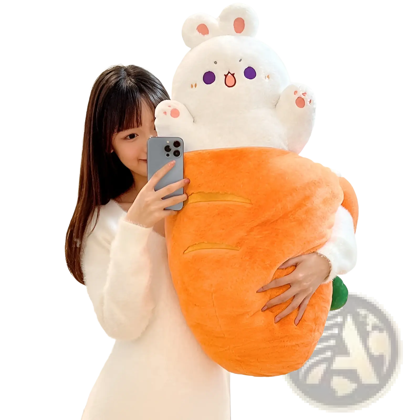 A plush white bunny with purple eyes and pink ears sitting on an orange carrot-shaped plush animal pillow