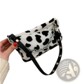 Black and white leopard-print plush animal print baguette bag with silver chain strap made of faux fur