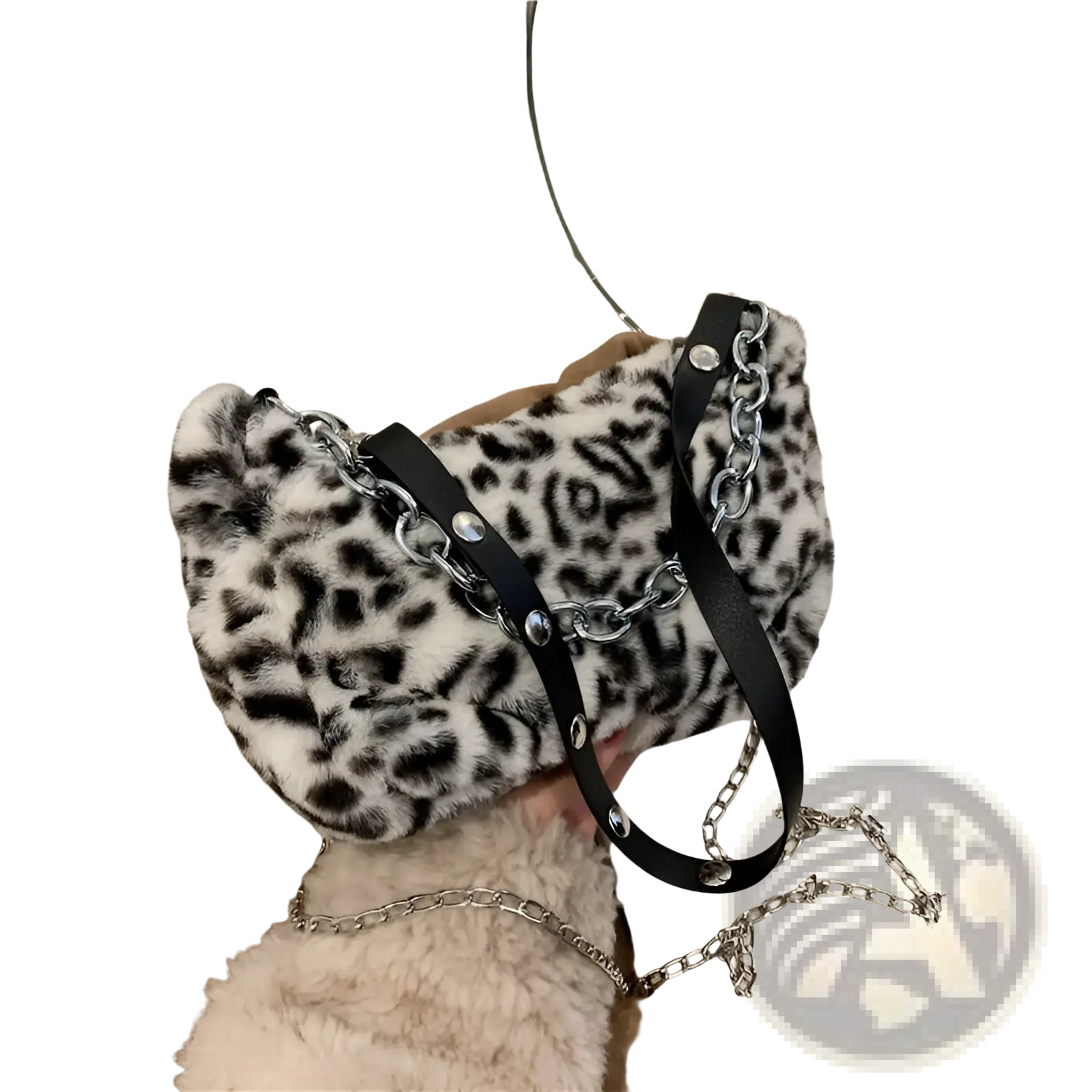A plush black and white leopard print baguette bag with a silver chain strap made of soft fabric