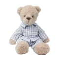 A soft cream-colored plush bear stuffed animal wearing light blue and white plaid pajamas with buttons