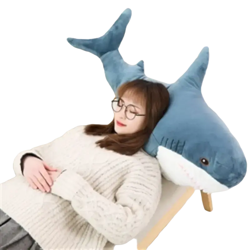 Plush blue shark stuffed animal pillow with white underbelly and black stitched details made of soft fabric